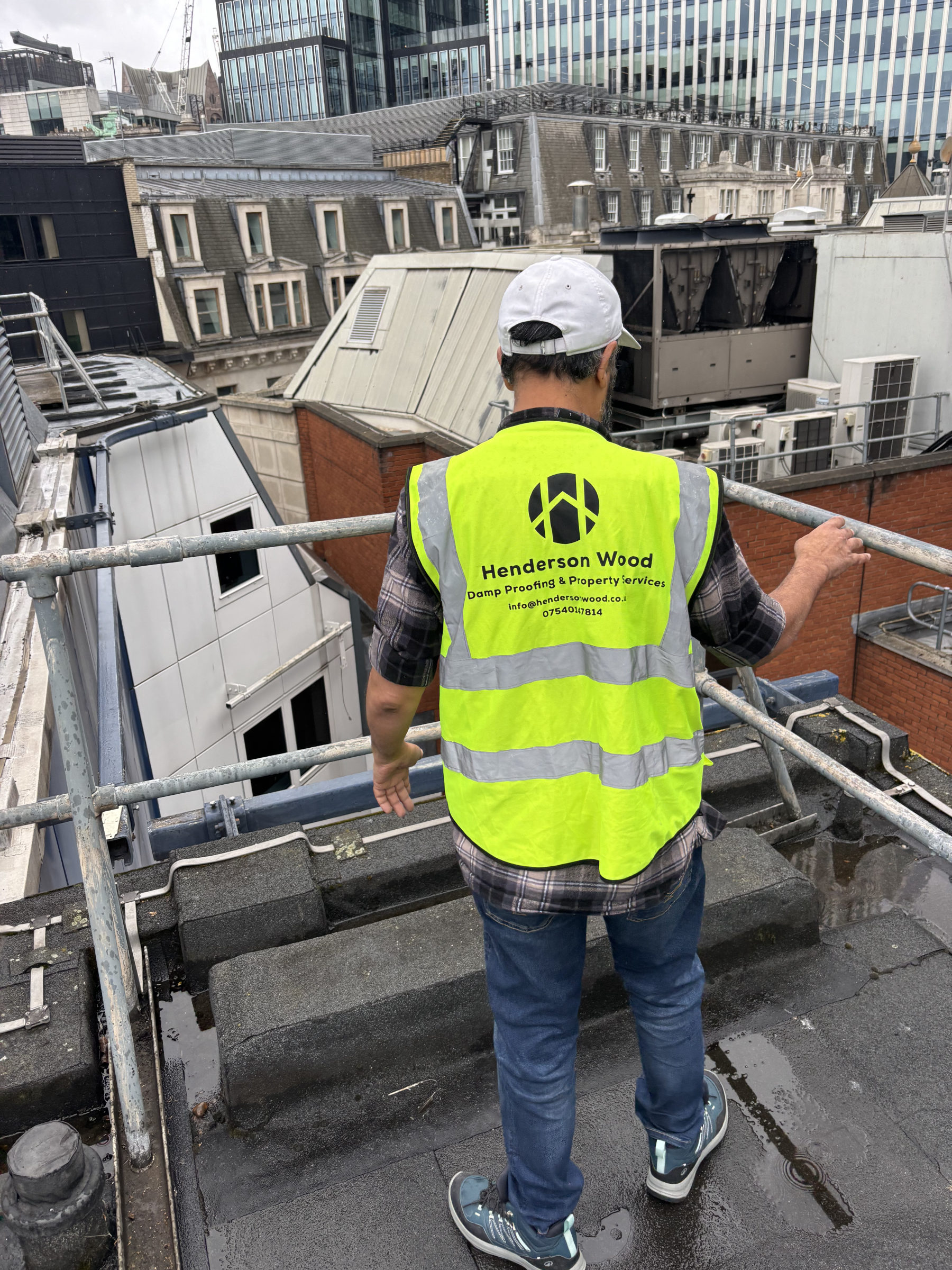 Henderson Wood surveyor assessing a large commercial roof in central London