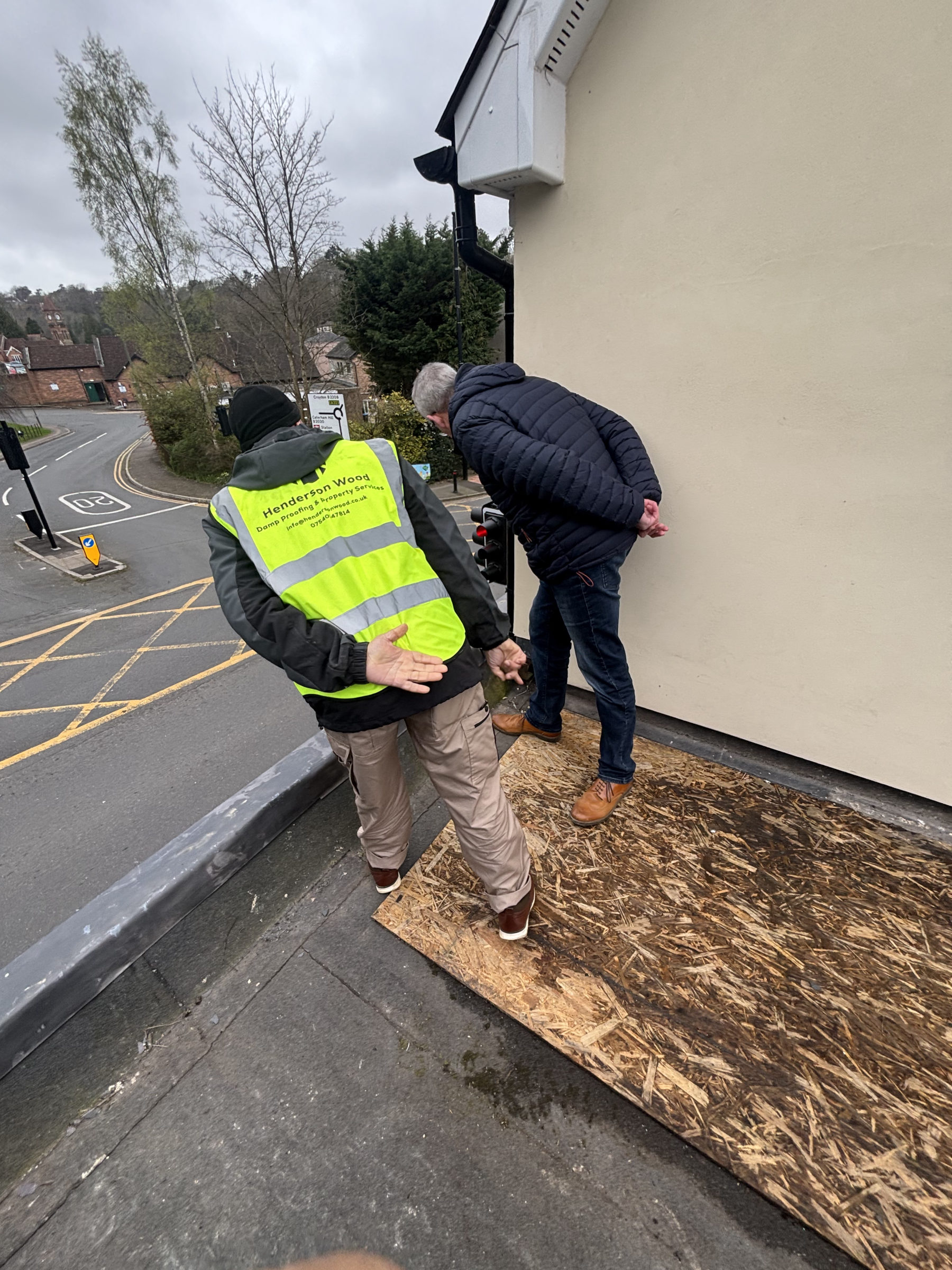 Henderson Wood surveyor verifying completed works with a client during a post-works inspection