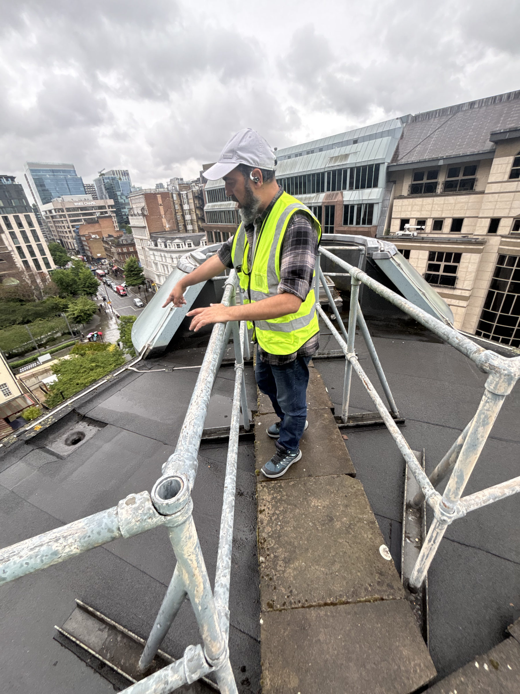 Henderson Wood surveyor reviewing roof maintenance on a managed London property